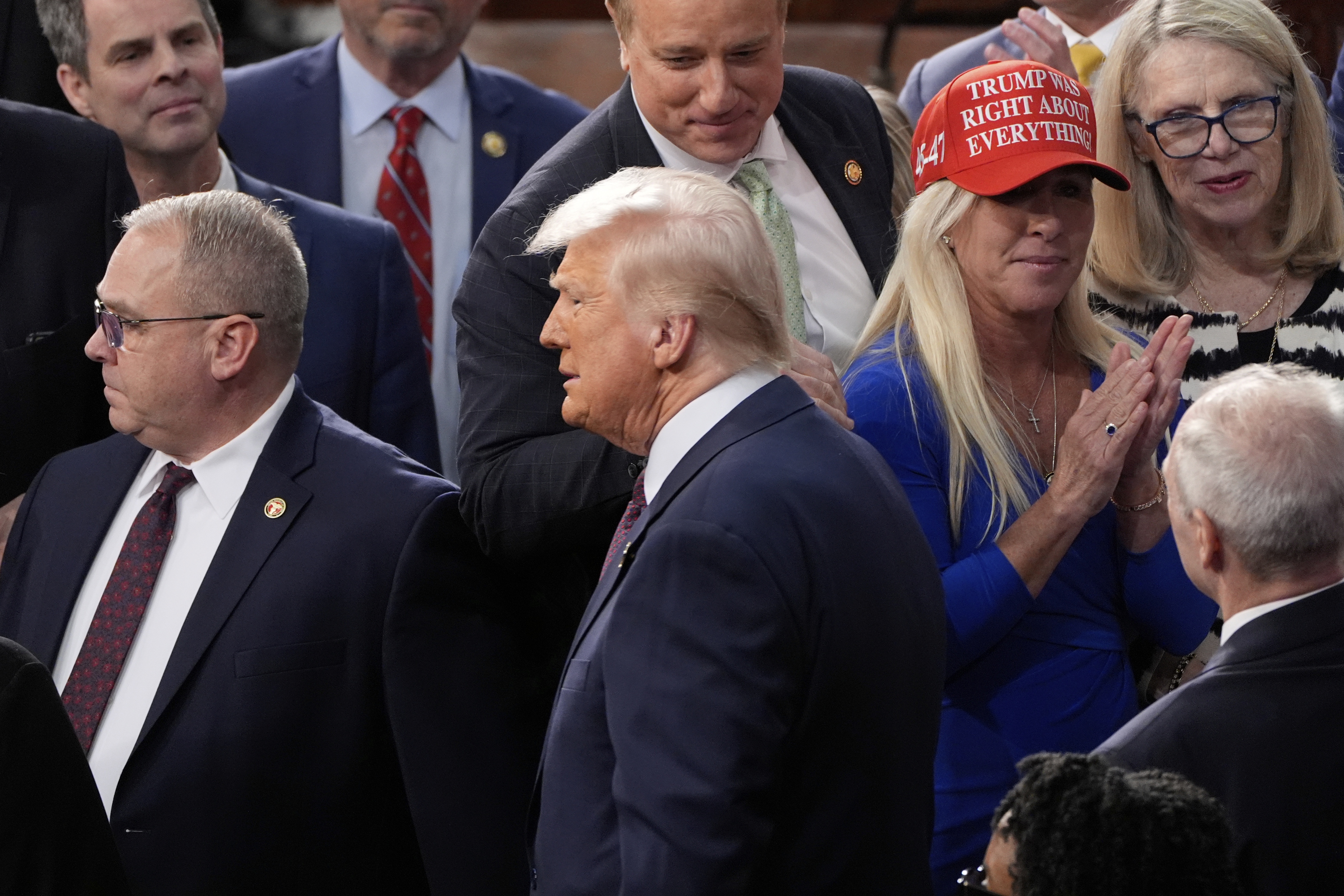 President Trump arrives after being greeted by Rep. Marjorie Taylor Greene, R-Ga., to address a joint session of Congress at the Capitol in Washington on March 4.